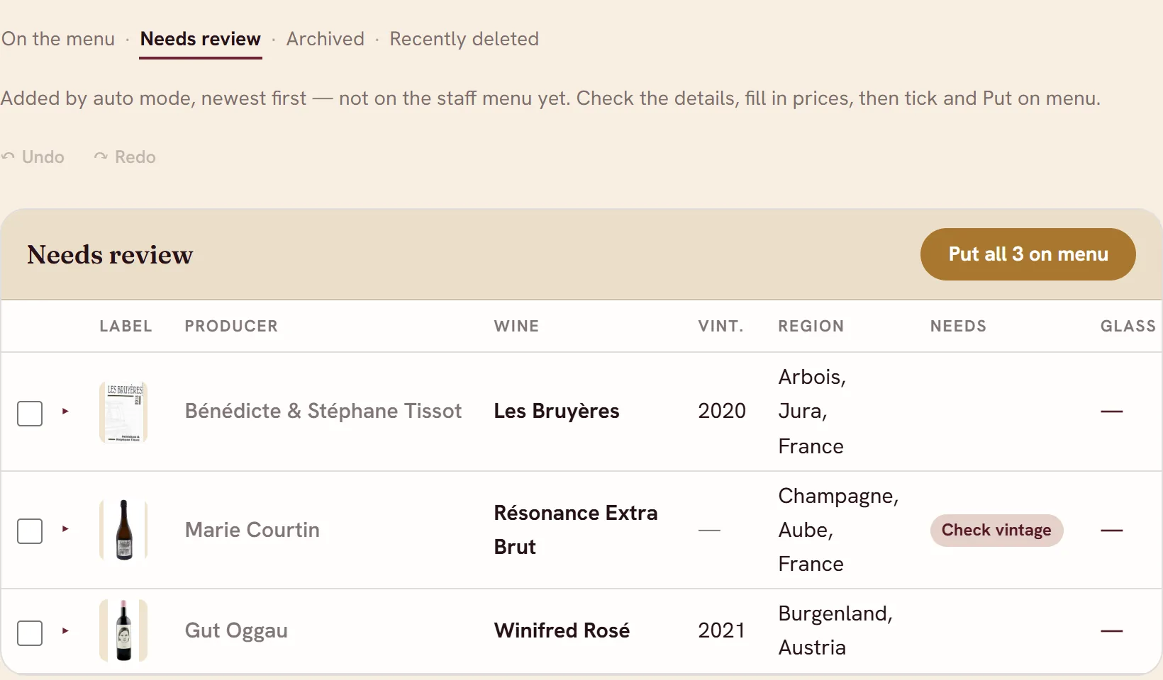 The Wine List's Needs review view: three new wines with their labels, and a Put all 3 on menu button